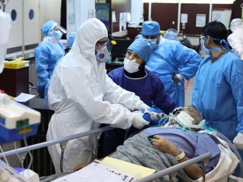 Emergency medical staff and nurses wearing protective suits, help while transferring a patient with coronavirus disease to Masih Daneshvari Hospital, in Tehran on March 30.