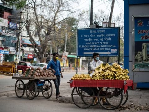 Fruit vendors on a street corner during Prime Minister Narendra Modi’s lockdown order for India’s 1.3 billion citizens to fight the spread of coronavirus, in New Delhi, India, March 26, 2020. Although selling food is deemed necessary and permissible during the lockdown, vendors are finding fewer customers.
