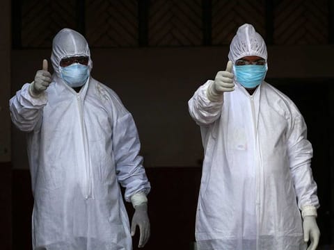Medical staff wearing protective gear prepare to test people, who attended a religious event at Nizamuddin Markaz in New Delhi where many have tested COVID-19 coranavirus positive, in Allahabad on April 1, 2020. 