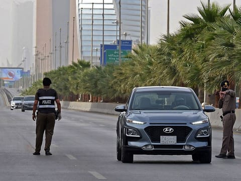 Saudi policemen manning a checkpoint in the King Fahad main street in the capital Riyadh.  