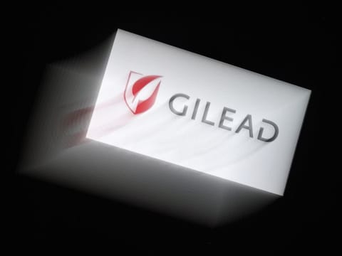 In this photo illustration a Gilead logo is displayed on a smartphone on March 25, 2020 in Arlington, Virginia. Gilead announced on March 25, 2020 that it has submitted a request to the Food and Drug Administration to rescind the exclusive marketing rights it had secured for remdesivir, an antiviral drug that shows promise in treating Covid-19, the disease caused by the new coronavirus. 