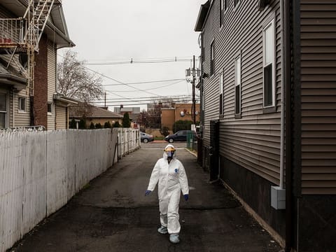 A medical worke walks toward tent setup outside Roseville Medical Group, to screen for the coronavirus, in East Orange, N.J., Friday, April 3, 2020. 
