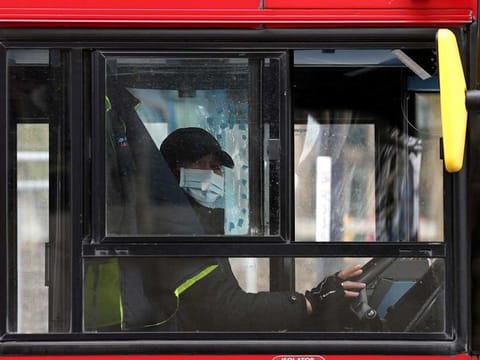 A bus driver wears a face mask, as the spread of the coronavirus disease (COVID-19) continues, in London, Britain, April 6, 2020. 