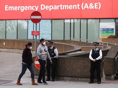 Police officers are seen outside St Thomas' Hospital after British Prime Minister Boris Johnson spent a second night in intensive care after his coronavirus (COVID-19) symptoms worsened on Monday, in London on April 8, 2020. 
