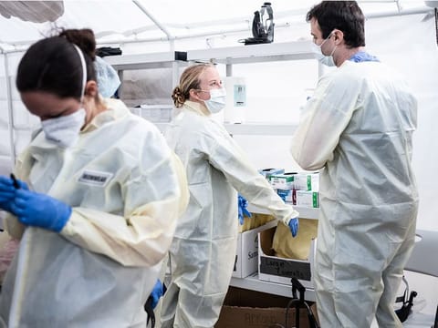 Medical workers putting on PPEs at the beginning of their shift at the emergency field hospital run by Samaritan's Purse and Mount Sinai Health System in Central Park on April 08, 2020 in New York, United States. New York City remains the epicenter of the coronavirus pandemic in the United States 
