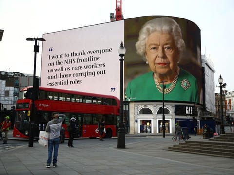 A message from Britain's Queen Elizabeth II is displayed on a screen in Piccadilly Circus, as the spread of the coronavirus disease (COVID-19) continues, London, Britain, April 8, 2020. REUTERS/Hannah McKay
