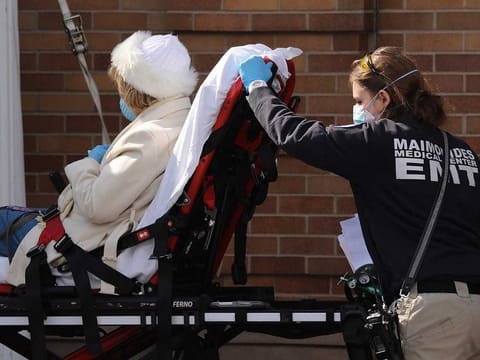 Medical workers take in patients at a special coronavirus intake area at Maimonides Medical Center on April 12, 2020 in the Borough Park neighborhood of the Brooklyn borough of New York City. Hospitals in New York City, which have been especially hard hit by the coronavirus, are facing shortages of beds, ventilators and protective equipment for medical staff.