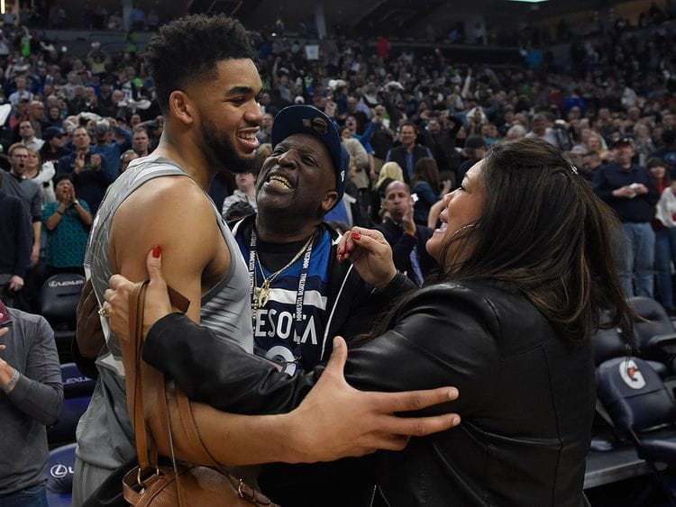 Karl-Anthony Towns of the Minnesota Timberwolves hugs his parents, Karl and Jackie Towns 