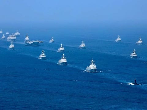 In this April 12, 2018, file photo released by China's Xinhua News Agency, the Liaoning aircraft carrier is accompanied by navy frigates and submarines conducting an exercises in the South China Sea.