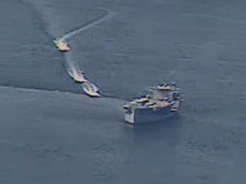 Iranian Islamic Revolutionary Guard vessels near US Navy ships in international waters of the Arabian Gulf. 