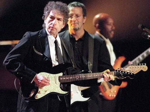 TO GO WITH STORY SLUGGED: BOB DYLAN--FILE--Rock and Roll legends Bob Dylan, left, and Eric Clapton, center, perform for a sold out crowd at New York's Madison Square Garden, in this June 30, 1999, file photo. In his fourty-year career, Dylan has released 43 albums and sold over 50 million recordings. (AP Photo/John Bellissimo/HO)