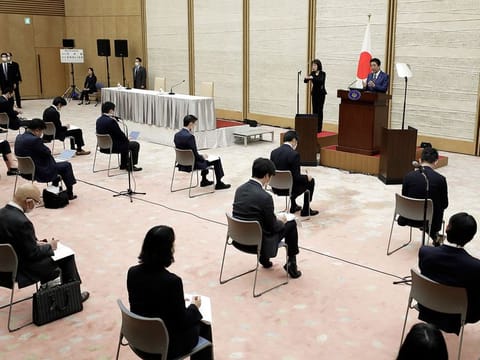 Shinzo Abe, Japan's prime minister, top right, speaks during a news conference at the prime minister's official residence in Tokyo, Japan, on Friday, April 17, 2020. 
