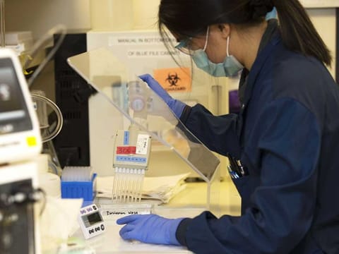 Medical laboratory scientist, Alicia Bui, runs a clinical test in the Immunology lab at UW Medicine, University of Washington, looking for antibodies against SARS-CoV-2, a virus strain that causes coronavirus disease (COVID-19) on April 17, 2020 in Seattle, US. 