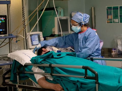 Nurse Pasqualina Conte tends to a patient in the emergency COVID-19 ward at the San Carlo Hospital in Milan, Italy.