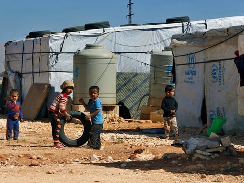  Syrian refugee children play outside their family tents at a Syrian refugee camp in the eastern city of Baalbek, Lebanon. The U.N. agency for Palestinian refugees said Wednesday, April 22, 20202, that a Palestinian woman from Syria living in a refugee camp in Lebanon has become the first refugee to test positive for the coronavirus. 