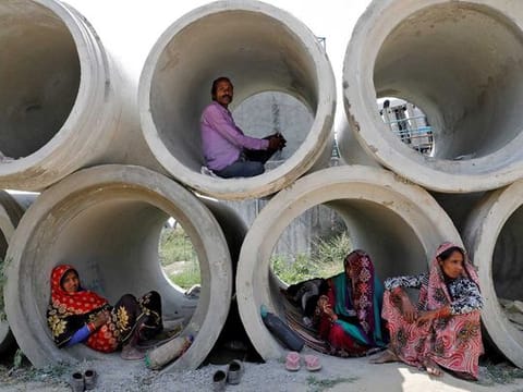 Migrant labourers rest in cement pipes during an extended nationwide lockdown to slow the spreading of coronavirus disease (COVID-19) in Lucknow, India, April 22, 2020