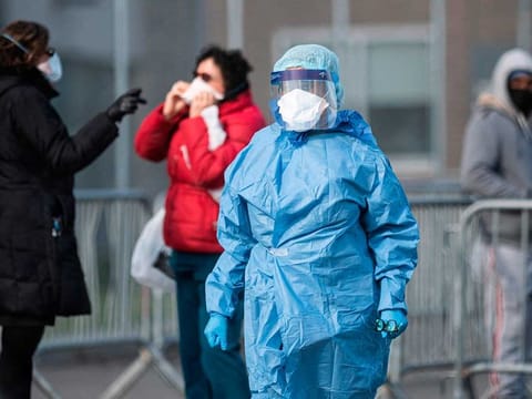 A medical worker at the NYC Health Hospital is seen in front of the COVID-19 testing site on April 22, 2020 in the Queens borough of New York City. The US - with nearly 45,000 deaths and more than 800,000 coronavirus infections - is the hardest-hit country, and healthcare infrastructure in major hotspots such as New York City has struggled to cope. 
