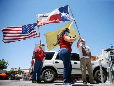 Protesters attend a Safely Open Texas Now rally on April 25, 2020, across the street from the El Paso County Court House in El Paso, Texas, US, during the coronavirus outbreak. 