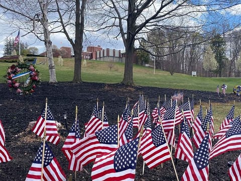 Flags and wreaths honour veterans, Tuesday, April 28, 2020, on the grounds of the Soldiers' Home in Holyoke, Mass., where a number of people died due to the coronavirus.