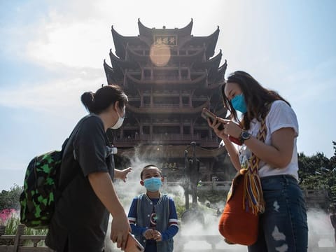 People visit Yellow Crane Tower after it reopened to the public in Wuhan in China's central Hubei province on April 29, 2020. 