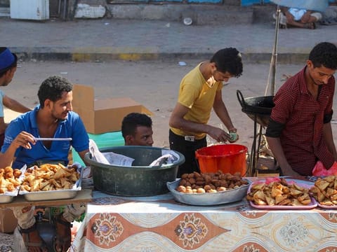 Yemeni street vendors wait for customers in the southern Yemeni city of Aden on April 27, 2020.
