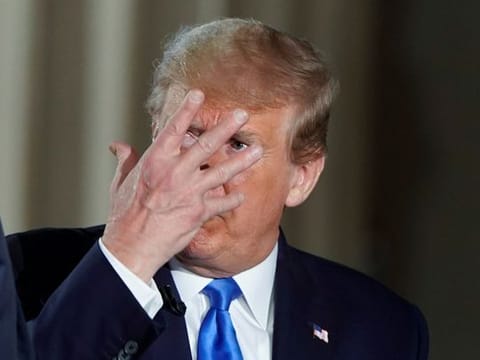 U.S. President Donald Trump gestures during a commercial break as the president participates in a live Fox News Channel virtual town hall