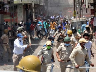 Photos: Migrant workers clash with police in Gujarat 