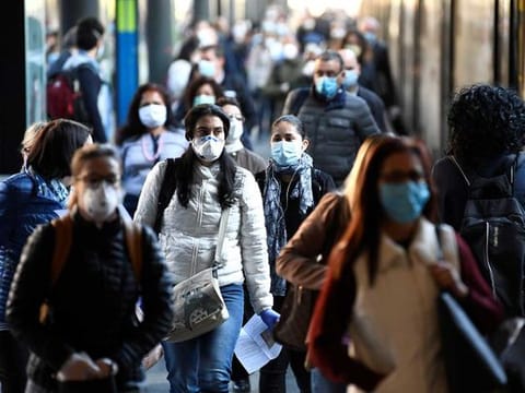 People wearing face masks arrive at the Cadorna railway station, as Italy begins a staged end to a nationwide lockdown due to the spread of the coronavirus disease (COVID-19), in Milan, Italy May 4, 2020. 