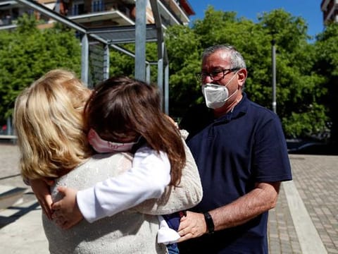 Domenico di Massa and Mariantonia Gangemi embrace their granddaughter Cecilia for the first time in two months after Italy allowed families to see each other again as the country begins a staged end to a nationwide lockdown due to a spread of coronavirus 