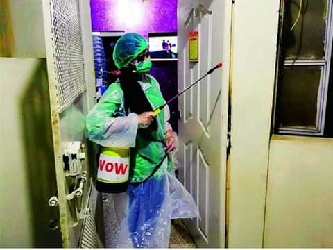 A worker of Voice of Women, a Karachi-based organisation, spraying as part of the disinfection campaign in Karachi. 