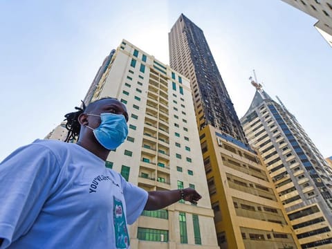 A resident pointing to Abbco Tower which caught fire