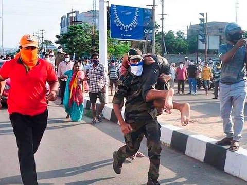 Rescuers evacuate people following a gas leak incident at an LG Polymers plant in Visakhapatnam on May 7, 2020.