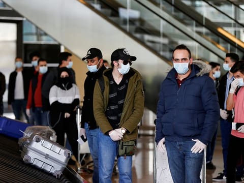 Jordanian students who were studying abroad, wait for their luggage after they returned to their home country amid concerns over the spread of the coronavirus disease (COVID-19), at Queen Alia International Airport, in Amman, Jordan May 6, 2020. 