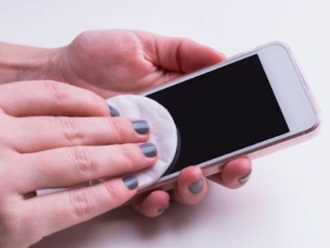 Illustrative image: A person cleaning a phone screen