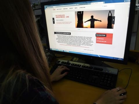 A resident looking at the UAE Alcoholics Anonymous website 