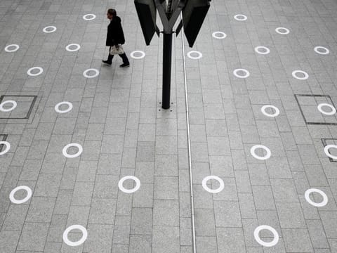 Plastic circles are seen on the ground indicating where to stand to respect social distancing at the Gare du Nord train station during the outbreak of COVID-19 in Paris, May 5.