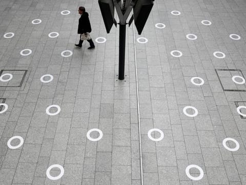 Plastic circles are seen on the ground indicating where to stand to respect social distancing at the Gare du Nord train station during the outbreak of COVID-19 in Paris, May 5.