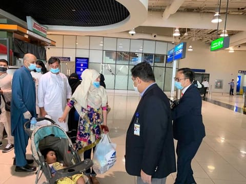 Stranded Pakistanis travelling from Dubai to Lahore on a special flight. File photo 