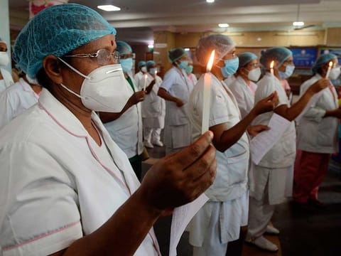Nurses light candles at Rajiv Gandhi hospital in Kochi on May 12, 2020, as the world marks International Nurses Day, celebrated on the birthday of Florence Nightingale. 