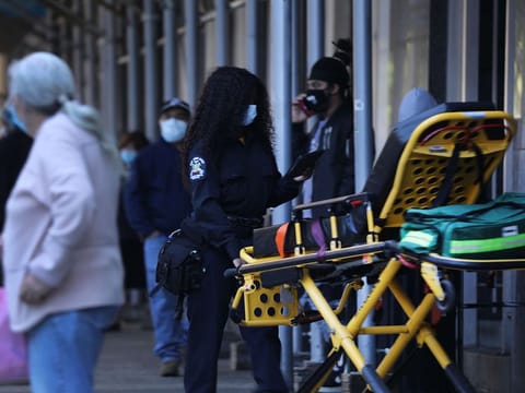 edics take a stretcher into a Manhattan hospital that has been at the forefront of the coronavirus outbreak on May 12, 2020 in New York City.