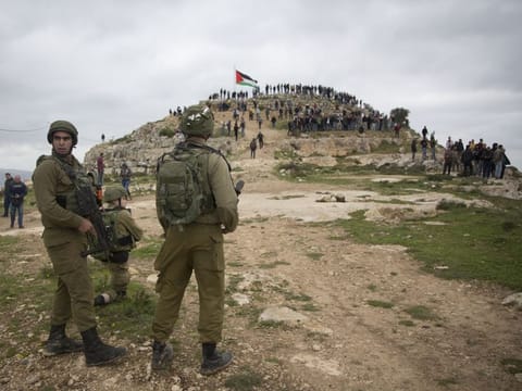 In this March 2 file photo, Israeli occupation regime soldiers take position as Palestinian demonstrators gather during a protest against expansion of Israeli colonies, in the occupied West Bank village of Beita near Nablus. 