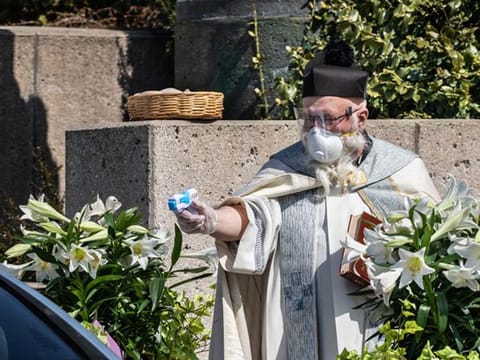 Priest uses squirt gun with holy water