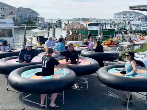 "Bumper tables" allow people to practice social distancing while eating and talking, are debuted at Fish Tales, a restaurant in Ocean City, Maryland.  