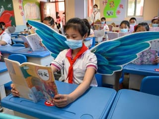 Students wear wings to maintain social distancing in China