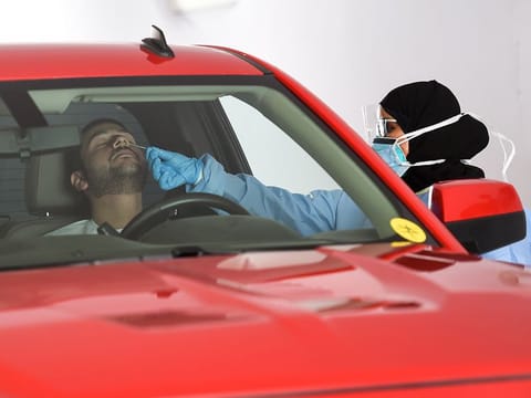 A paramedic collects swab sample at a Seha drive through National Screening Center in UAE. Picture for illustrative purposes only.