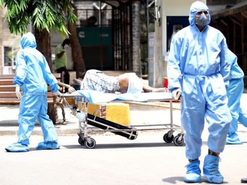 COVID-19 patients being brought by hospital staff at the KEM Hospital in Mumbai on Tuesday. 