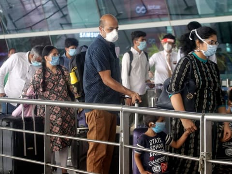 Passengers at the entrance to Indira Gandhi International Airport in New Delhi, following resumption of domestic flight services on Monday.