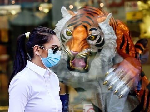 A resident wearing mask walks past a showroom in Bur Dubai. 