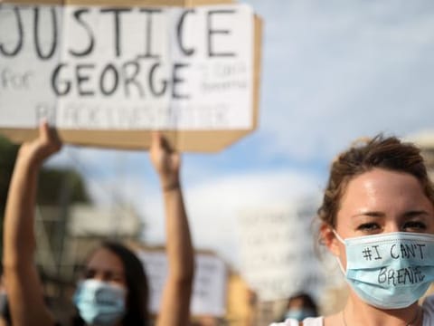 People wear protective face masks during a protest against the death in Minneapolis police custody of George Floyd, in front of a U.S. consulate, in Barcelona, Spain 