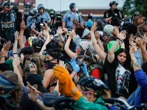 Protesters raise their hands on command from police as they are detained prior to arrest and processing at a gas station on South Washington Street, Sunday, May 31, 2020, in Minneapolis. Protests continued sparked by the death of George Floyd, who died after being restrained by Minneapolis police officers on May 25.
